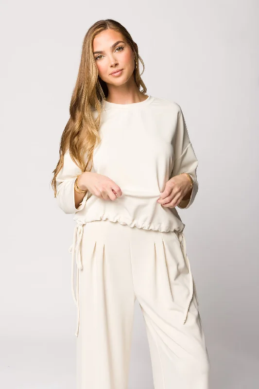 Iconic women’s outfits that never go out of style Marilyn Long Sleeve Tie Top and Pleated Sweatpants Set in Ivory Iconic women’s outfits that never go out of style Marilyn Long Sleeve Tie Top and Pleated Sweatpants Set in Ivory